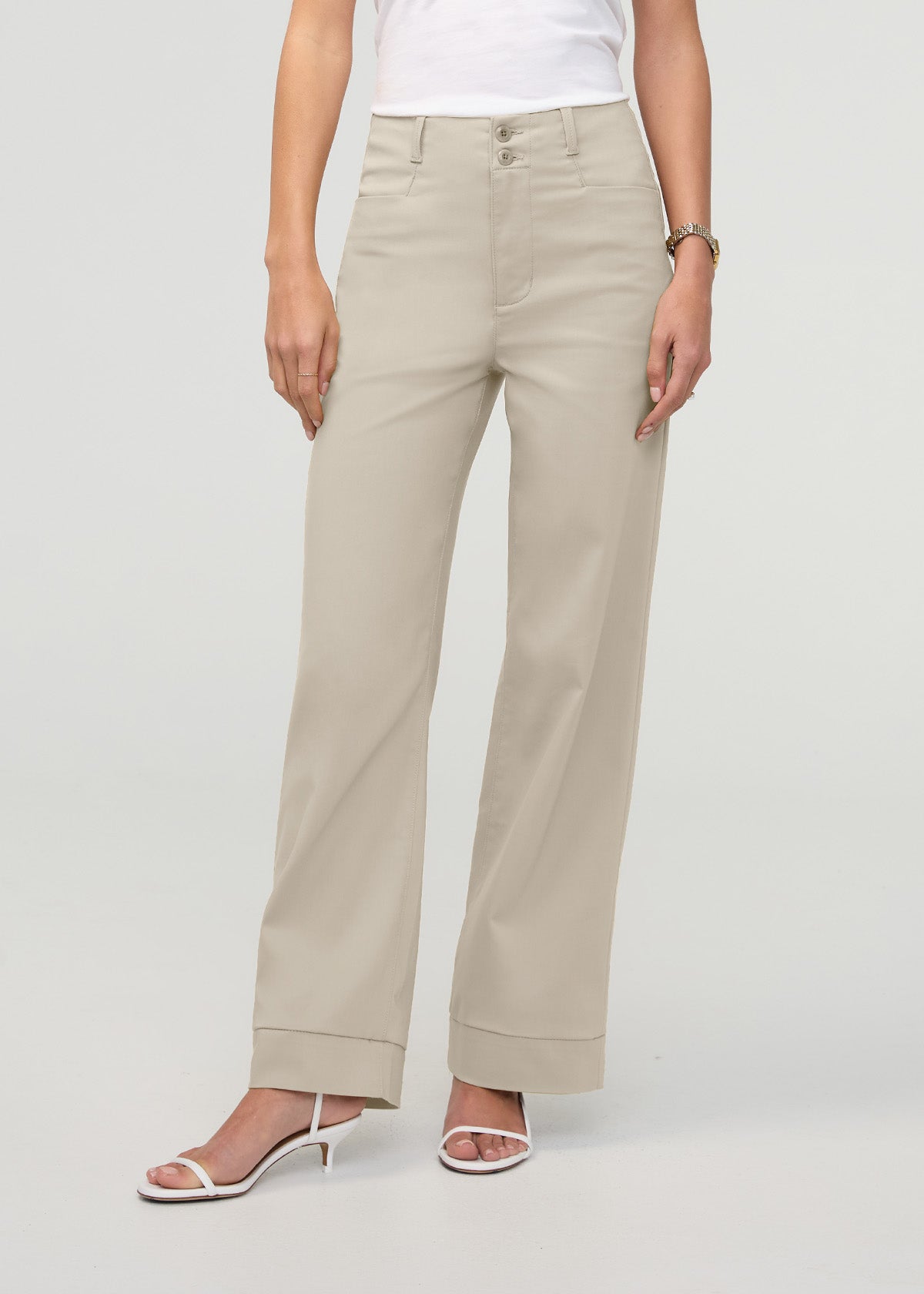 Sandstone high-rise trouser with straight legs and cuffed hem, shown on model wearing white top and white sandals.