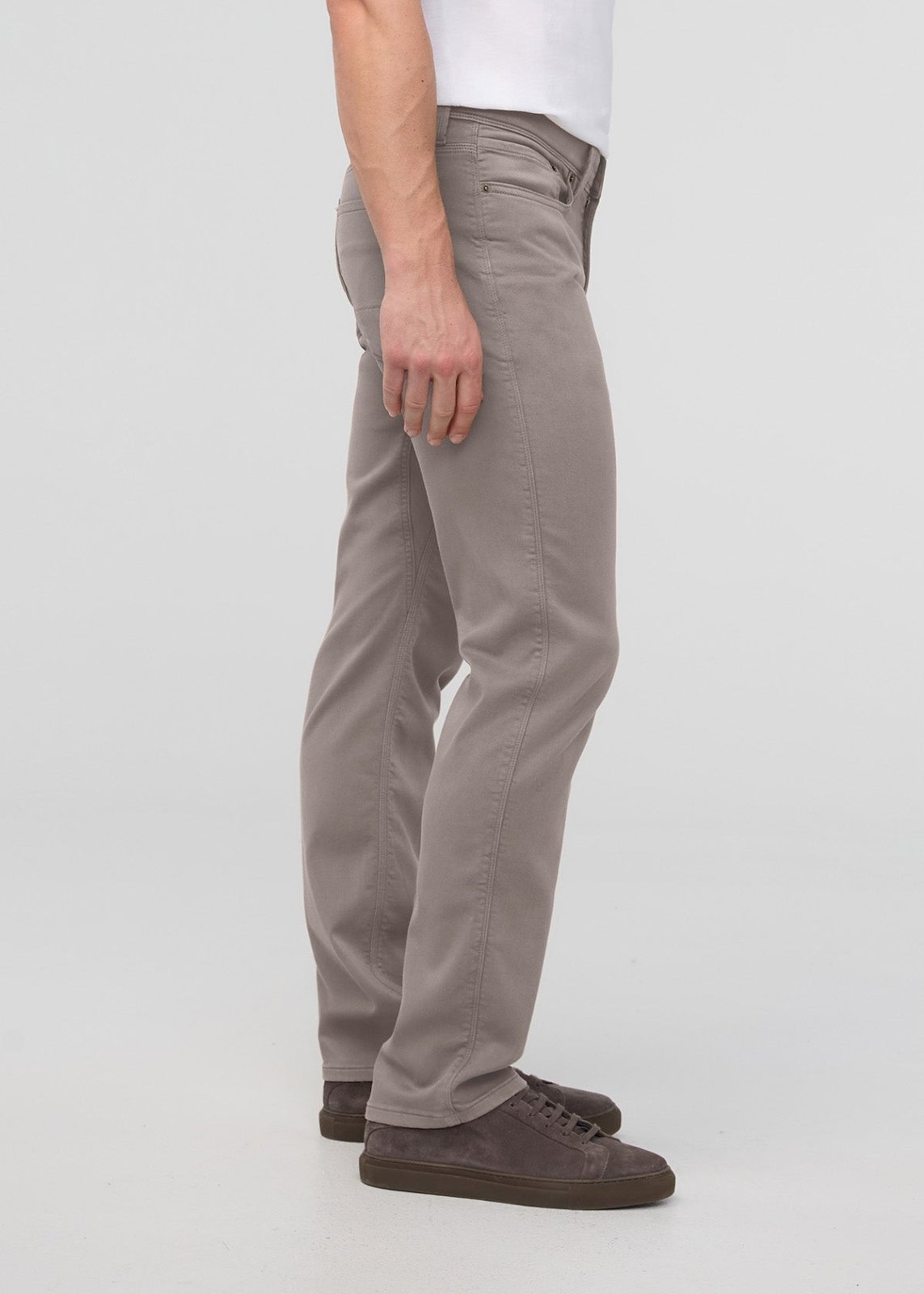 Stone-colored straight-leg pants with button fly and five-pocket styling, shown on model wearing white shirt and dark sneaker