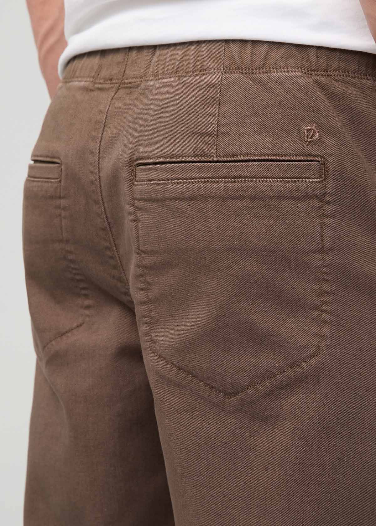 Tan pull-on pants with elastic waistband, back pocket detail, and brand logo visible on rear.
