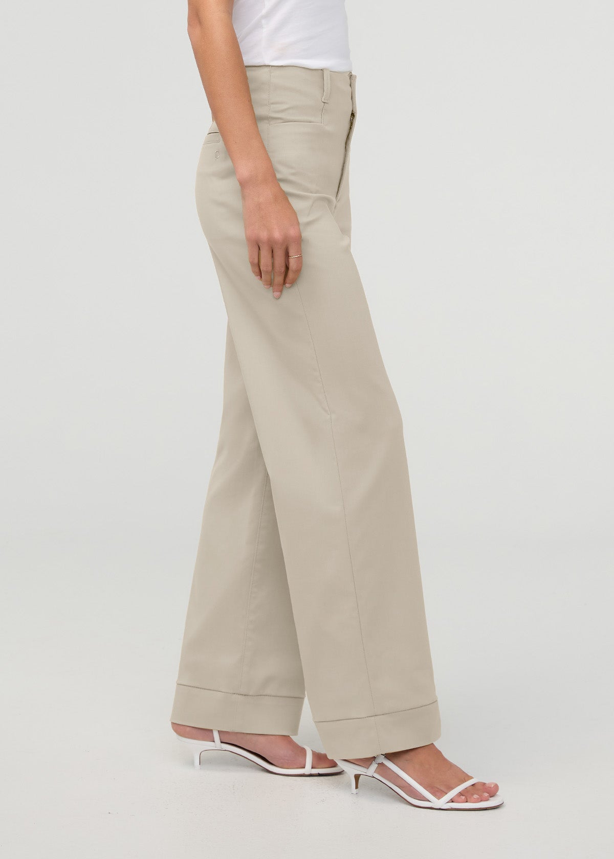 Sandstone high-rise trouser with wide leg and cuffed hem, styled with white top and sandals.