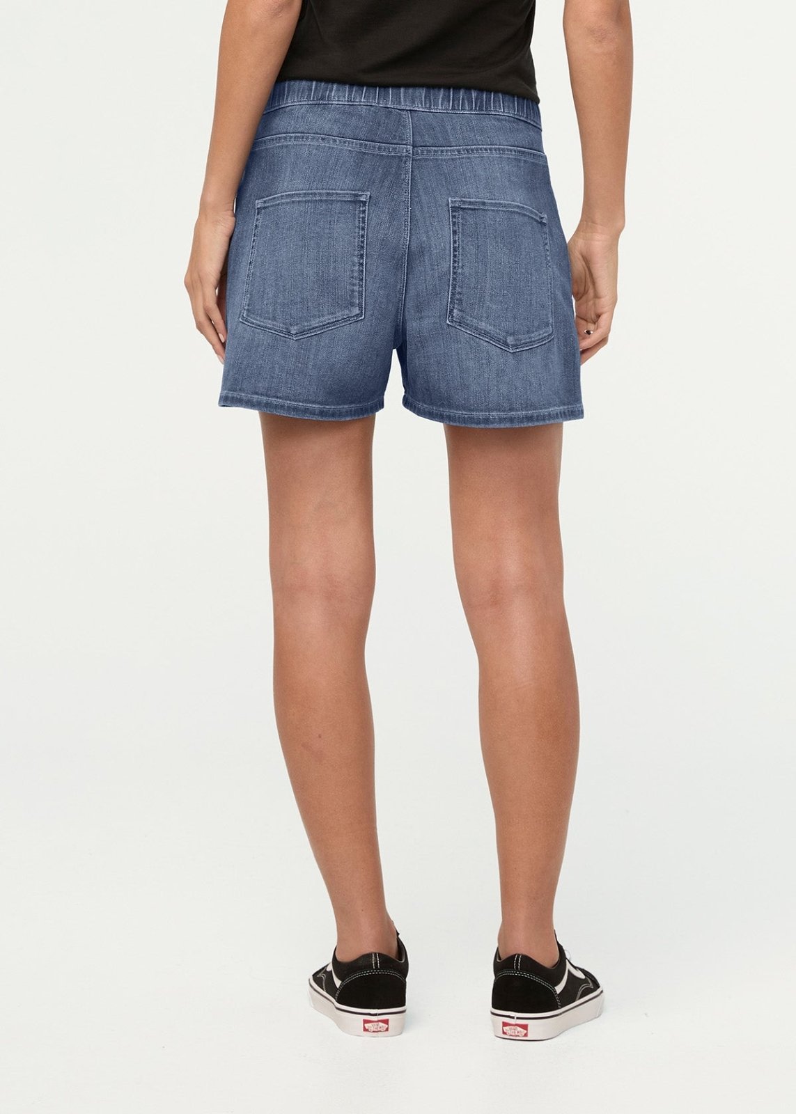 Light blue denim shorts with back pockets, elastic waistband, worn with black top and black sneakers.